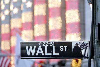 Image: A Wall Street sign is seen in front of the New York Stock Exchange. | Photograph: Mario Tama/Getty Images