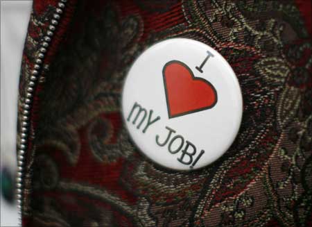 A recruiter wears a button at the Employment Guide job fair in Westminster, Colorado. | Photograph: Rick Wilking/Reuters