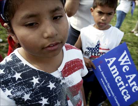 Jocelyn Flores (L) and her cousin Chris Flores take part in a rally in support of immigration rights in Washington. | Photograph: Jim Young/Reuters