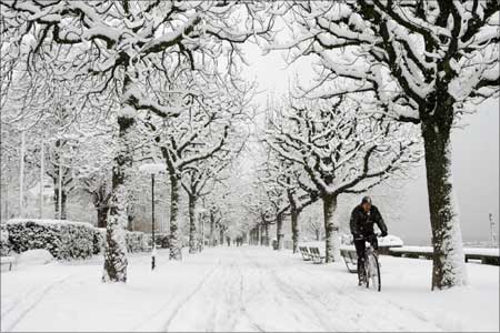 A man cycles during snowfall in Zurich, Switzerland.