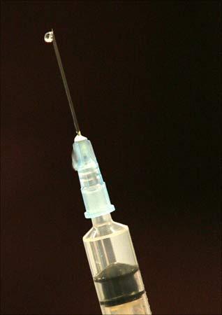 A syringe filled with water at the start of a mock mass vaccination in Bolton, northern England