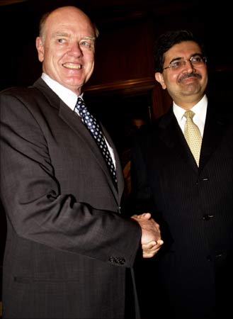 Former US Treasury Secretary John Snow shakes hands with Uday Kotak in Mumbai