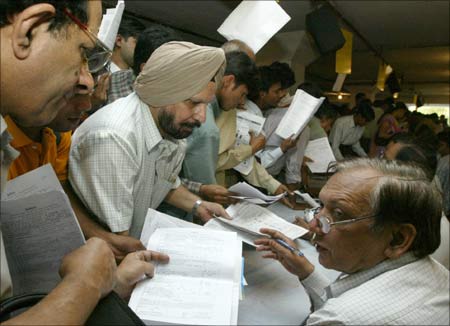 Indian tax payers line up to submit their income tax returns. | Photograph: Kamal Kishore/Reuters