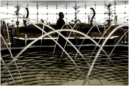 A man passes by a fountain at the Burj Al Arab Hotel in Dubai.