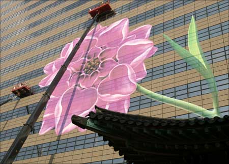 Designers and workers decorate the headquarters of Kyobo Life Insurance in central Seoul. | Photograph: Lee Jae-Won/Reuters