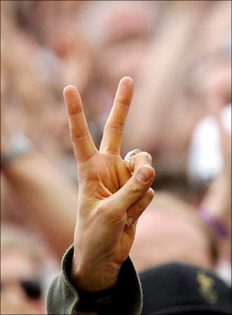 A successful student holds up his hand to signal victory in London. | Photograph: Stephen Hird/Reuters