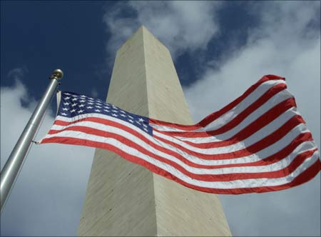 The Washington Monument is seen with an American flag flying in the foreground in Washington. Molly Riley/Reuters