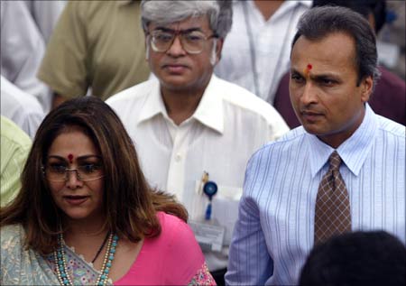 Anil Ambani and his wife Tina (L) enter the campus of group company Reliance Infocomm Ltd in Mumbai.