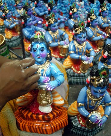 A worker gives finishing touch to the idols of Hindu deity Lord Krishna at a workshop in Chennai. | Photograph: Babu/Reuters