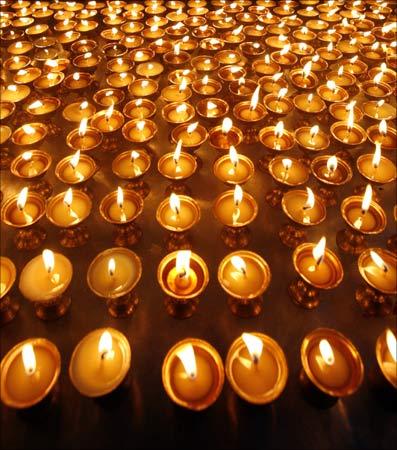 Lamps are lit during a candlelight vigil held by exiled Tibetans living in India to mark the 50th anniversary of a failed uprising that prompted Dalai Lama's flight into exile in Mcleodganj. | Photograph: Fayaz Kabli/Reuters