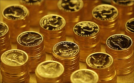 Gold bullion coins known as Krugerrands pictured in the mint where they are manufactured in Midrand outside Johannesburg. | Photograph:  Siphiwe Sibeko/Reuters