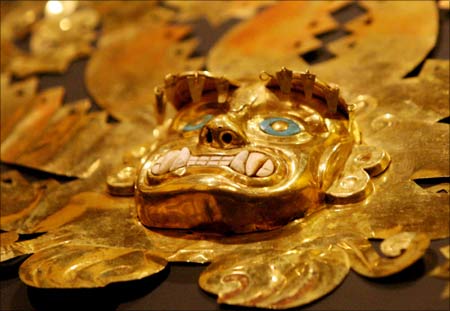 The detail of a Peruvian headdress made of gold by the Mochica pre-Hispanic culture depicting an image of a sea god at the foreign ministry in Lima. | Photograph:  Mariana Bazo/Reuters