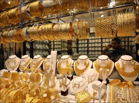 A shopkeeper sits in his shop in Dubai's gold souk. | Photograph:  Tamara Abdul Hadi/Reuters