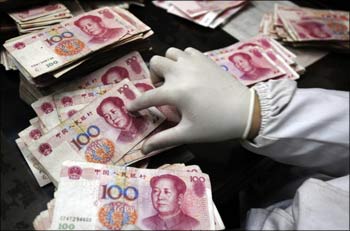 An employee counts Renminbi banknotes.