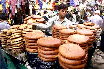A man sells baked bread in Kolkata.
