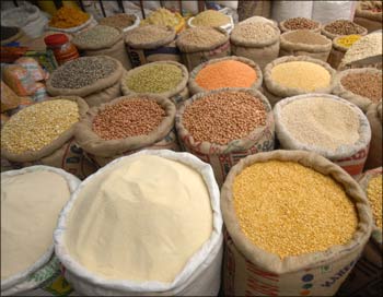 A vendor sells cereals at a grocery shop in Hyderabad.