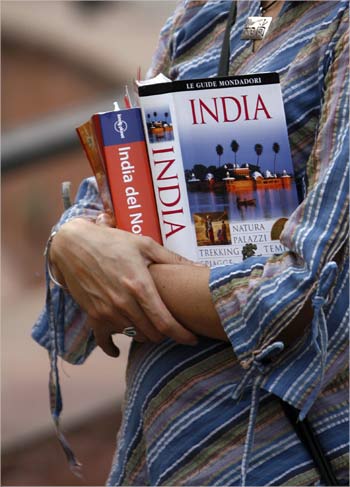 A foreign tourist holds tourist guide books as she visits the Red Fort in the old quarters of Delhi.