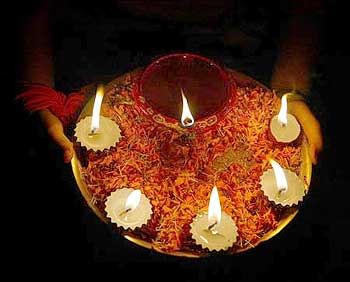 A girl holds lighted lamps during Diwali celebrations in Siliguri.