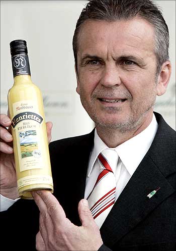 Chief executive Gunter Heise of Rotkaeppchen-Mumm winery poses for the media with a bottle of bioegg liqueur.