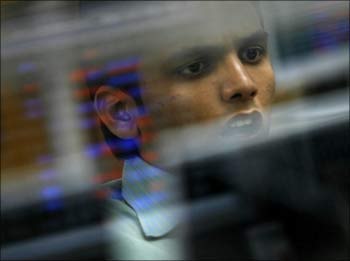 A broker reacts while trading at a stock brokerage firm in Mumbai.