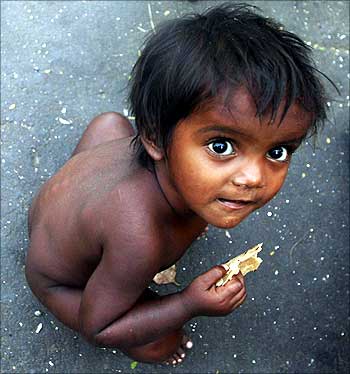 A boy eats roti at a slum in Mumbai.