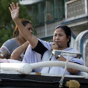 Mamata Banerjee, chief of Trinamool Congress party, waves her hand during an election rally in Kolkata.