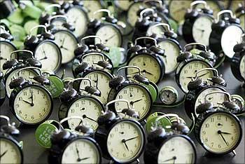 Clocks are seen during the performance - tck tck tck -- by Global Campaign for Climate Action at the Barcelona Climate Change Talks.