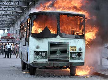A passenger bus burns after it was set on fire by a mob during a protest in Kolkata.