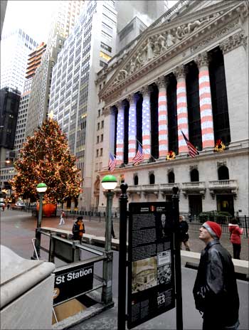 A tourist reads a historical marker outside the New York Stock Exchange shortly after the exchange opened for business on the last day of 2008.