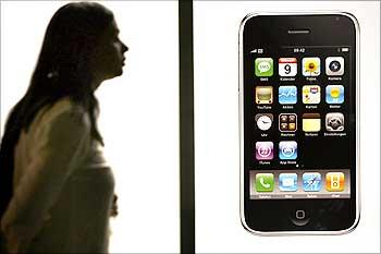 Woman walks past Swisscom store before joining queue to buy Apple's iPhone 3G after it went on sale in Zurich.