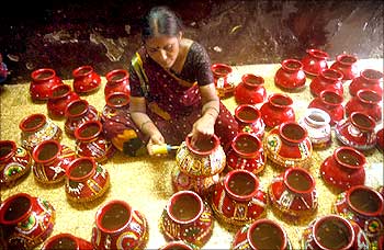 A woman makes earthen pots for Navratri in Dharavi Kumbharwada.
