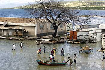 Haitians make their way in a flooded road on the border between Haiti and Dominican Republic.
