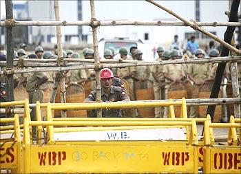 Tata Motors security personnel and policemen stand guard at Singur factory.