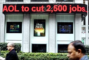 News of AOL cutting 2,500 jobs is seen on an electronic news ticker in New York.