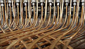 Copper cooling tubes are pictured on the 50-giga-electron-volt synchrotron under construction.