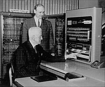 Thomas Watson, Sr. (seated) the CEO of IBM in 1952 using the IBM 701 computer, the company's first fully electronic model.