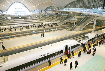 Travellers board a high-speed train which heads to Guangzhou in Wuhan, Hubei province.