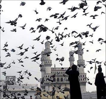 Image: Pigeons fly against the backdrop of the historic Charminar monument in Hyderabad. Photograph: Krishnendu Halder/Reuters