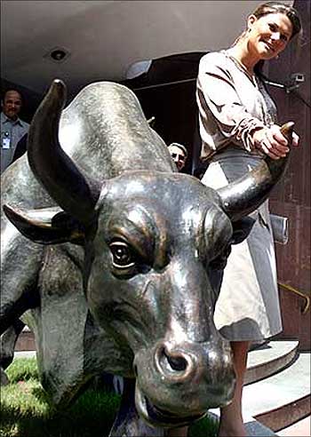 Sweden's Crown Princess Victoria poses with a bronze replica of the bull during her visit to the BSE