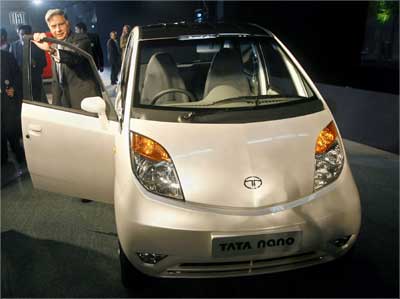 Tata Group chairman Ratan Tata poses with the Nano. | Photograph: Adnan Abidi/Reuters n