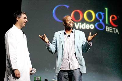 Larry Page is joined by former NBA star Kenny Smith during the former's keynote speech at the Consumer Electronics Show in Las Vegas