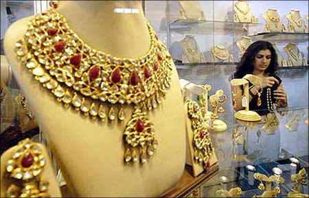 A visitor tries on jewellery during the three-day International Gems and Jewellery Expo in Hyderabad.