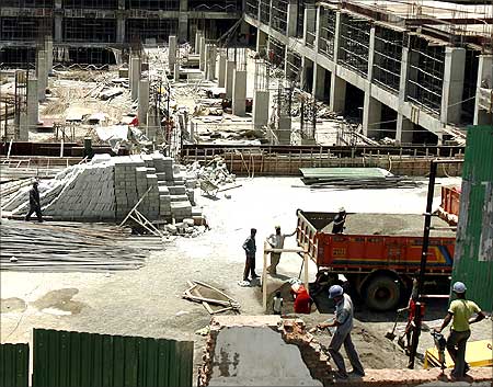 Labourers work at the construction site of a building.