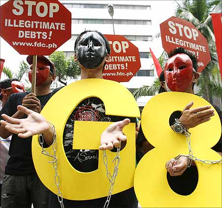 Protesters wearing masks stage a protest in front of the World Bank office in Manila.