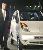 Ratan Tata poses along side a Nano