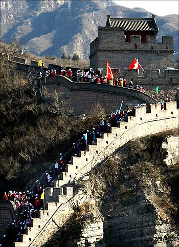People carrying AIDS awareness flags walk along the Great Wall of China located near Beijing.