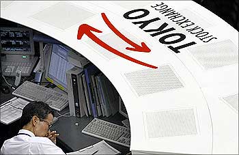 A staff of the Tokyo Stock Exchange works at the centre where it monitors stock trading.