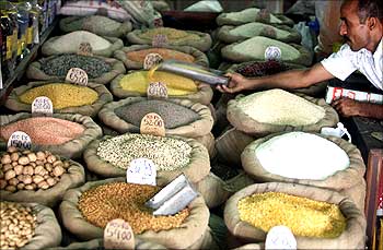 A shopkeeper sells pulses.