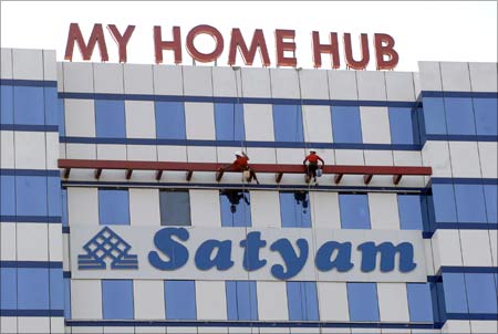 Labourers clean the Satyam building in Hyderabad. The Satyam scam shocked corporate India.