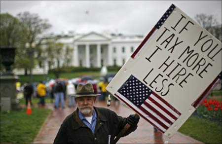 A man participates in a rally as part of national Tax Day in Lafayette Park across from the White House in Washington.